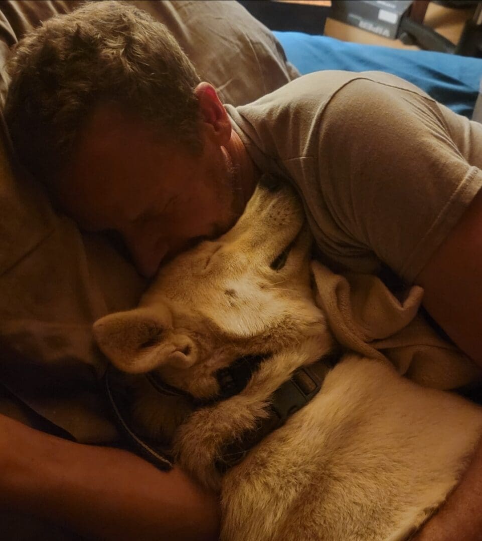 A man and his dog sleeping on the bed